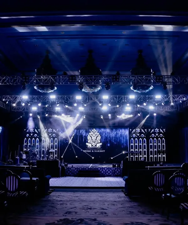 The main stage for Neomi and Rakshit's 'Gothic Palace Ball' Sangeet. The dramatic lighting, large LED screen with a custom monogram, and Gothic-inspired side panels created a spectacular setting for the night's performances.