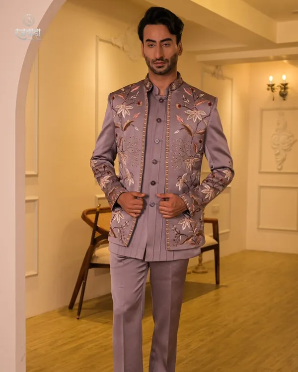 A full-length view of our mauve floral embroidered Jodhpuri suit. This three-piece ensemble includes the jacket, a matching kurta, and trousers, offering a complete, cohesive look for a groom or wedding guest.