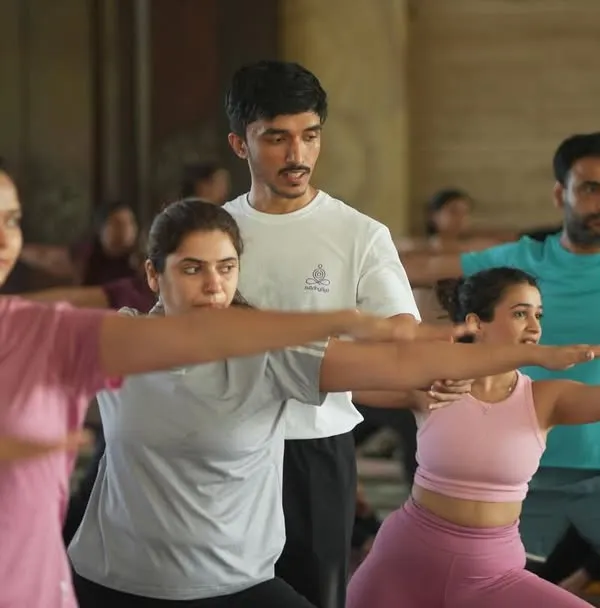 Here in our shala, you are never just a face in the crowd. This is what our practice looks like: a shared space where the energy of the group lifts you, while personal guidance from our teachers ensures your alignment and safety. We are here to help you find your strength in poses like Virabhadrasana II, the warrior pose.