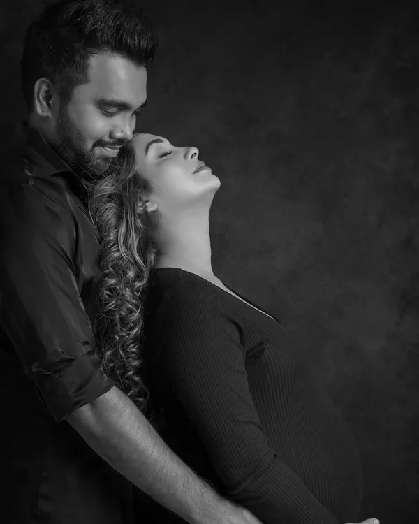 Stripped of color, the focus shifts to pure emotion. This black and white portrait captures the deep connection and peaceful love between the expecting couple.