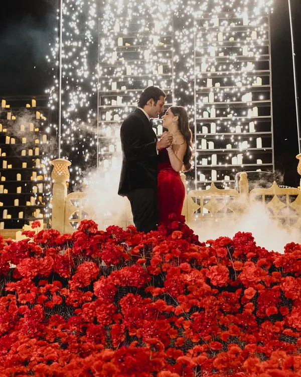 A moment suspended in time. For this reception in Jaisalmer, we created a universe of romance with a field of crimson flowers under a sky of a thousand candles and exploding fireworks. This is more than decor; it's the feeling of a grand love story reaching its crescendo, designed to be felt, not just seen.