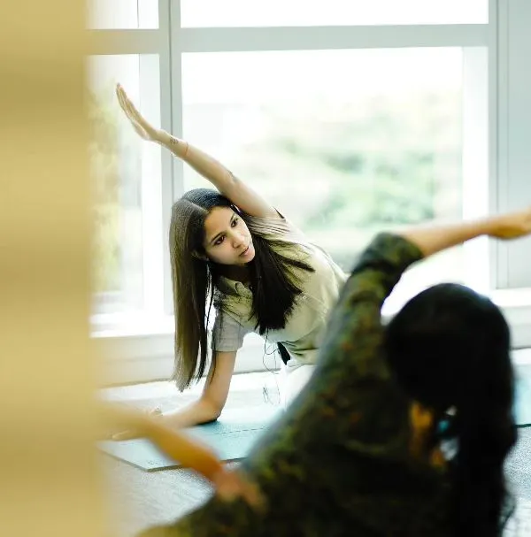 Here I am guiding a student through Trikonasana, or Triangle Pose, during a corporate wellness session. I focus on proper alignment to ensure you get the full benefits of each posture safely. These classes are a great way to build strength and flexibility.