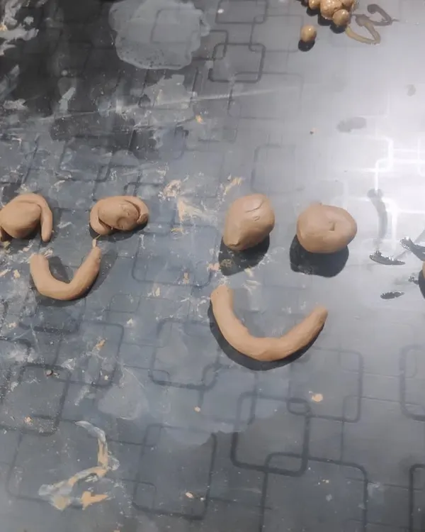 This piece was made by a nine year old on the spectrum. What might seem simple at first glance is actually a profound expression of emotion, using basic clay shapes to convey different feelings. It is a powerful example of clay as a conversation tool.