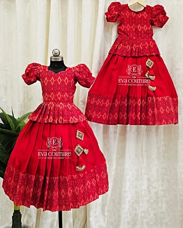 A perfect example of a sibling twinning set. These two red Ikat lehengas are made in different sizes for sisters.