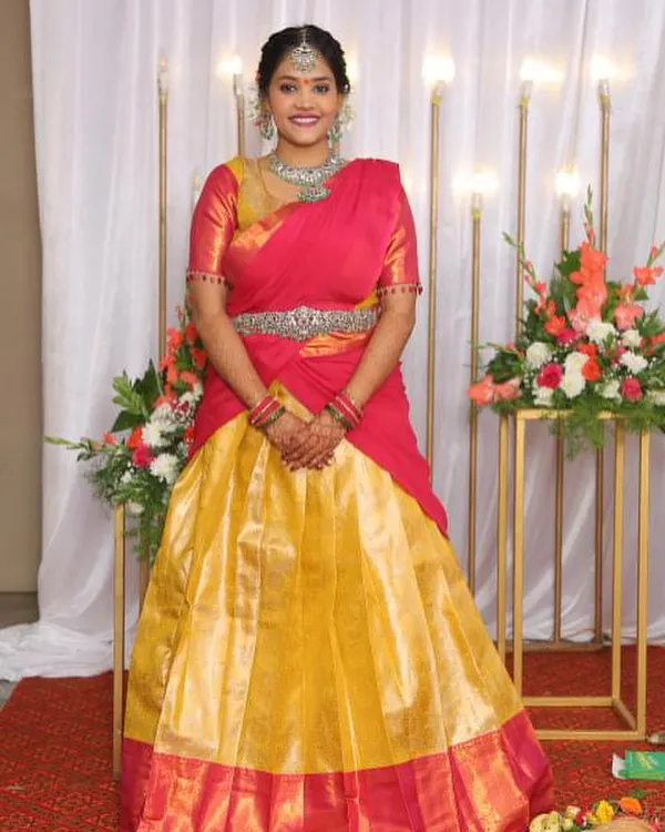 A happy client in her custom-designed Langa Davani for her big day. The vibrant combination of a yellow skirt and a pink blouse with a matching davani creates a classic and joyful look.
