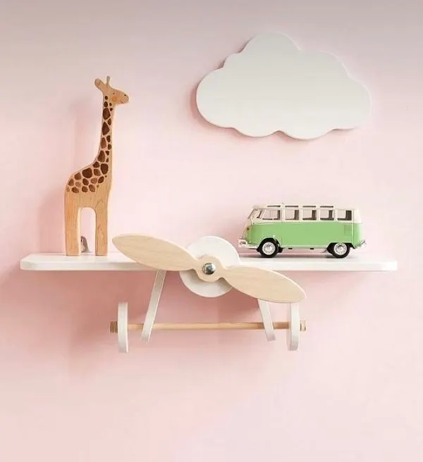 Let their imagination take flight with this airplane-themed nursery shelf. It’s crafted from solid wood with a spinning propeller, making it a delightful and sturdy spot for displaying small toys and decor.