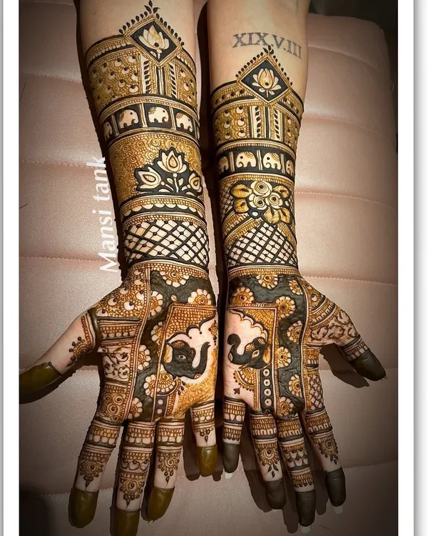 A stunning example of a full coverage bridal design. This henna features a mix of bold and fine lines, with elephant motifs, lotus flowers, and geometric jaal patterns for a truly grand look.