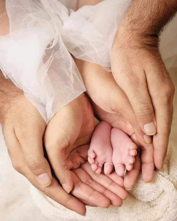 Sometimes the most powerful photos are in the tiny details. I love capturing shots like this, with a newborn's perfect little feet held securely in their parents' hands. It’s a beautiful symbol of family and protection.