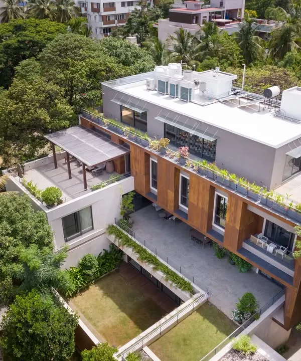 An aerial view of The U-L-I Residence, a 25,000 sq. ft. home designed for a multigenerational family. The architecture organizes shared public spaces on the ground floor and private family units above, all connected by a series of courtyards and green spaces.