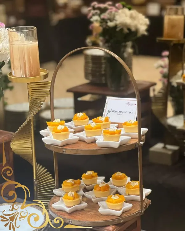 A little bite of sunshine. These mini mango cheesecakes are a seasonal favorite, served on individual star shaped plates and displayed on a rustic two tiered stand.