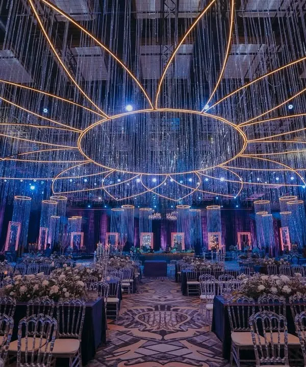 Step into a world of shimmer and song. For this Sangeet, I designed a magnificent ceiling installation where strings of crystals radiate from a central point, creating a massive floral-inspired canopy of light that set the stage for an unforgettable celebration.