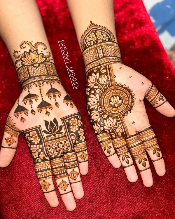 This design is a beautiful symphony of traditional Indian motifs. It features jhumka earrings, lotus flowers, and a central mandala, creating a different yet complementary look on each hand.