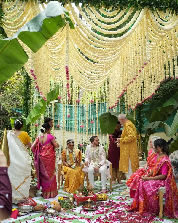 An intimate wedding ceremony doesn't mean compromising on beauty. This mandap, created with curtains of fragrant tuberose and framed by lush banana leaves, was designed to feel both sacred and deeply personal for a beautiful South Indian wedding.