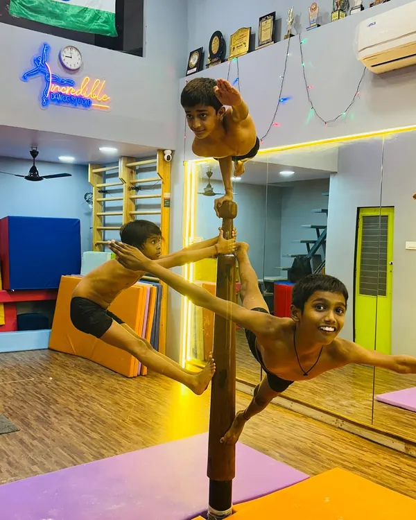 We believe in teamwork and pushing boundaries. Here, our advanced students demonstrate incredible strength, balance, and coordination, performing a complex group formation on the Mallakhamb pole. This level of acrobatic skill is built through consistent practice and mutual support.