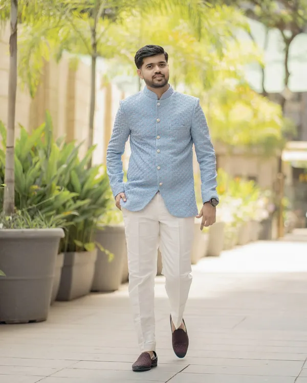 A classic full-length portrait of the groom. His confident walk and stylish ethnic wear are perfectly captured in this bright, outdoor shot.