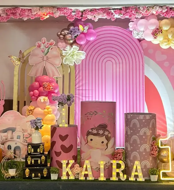 A beautiful enchanted garden theme for Kaira's first birthday, featuring a large teddy bear, mushroom house props, and delicate butterfly details.