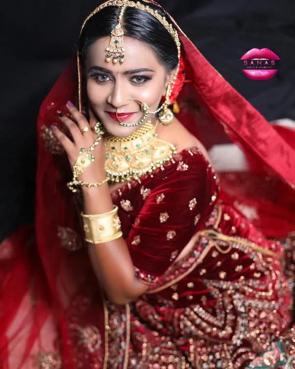 A stunning royal bridal look created for a portfolio shoot. This image showcases a complete look with velvet lehenga, heavy jewelry, and dramatic eye makeup.