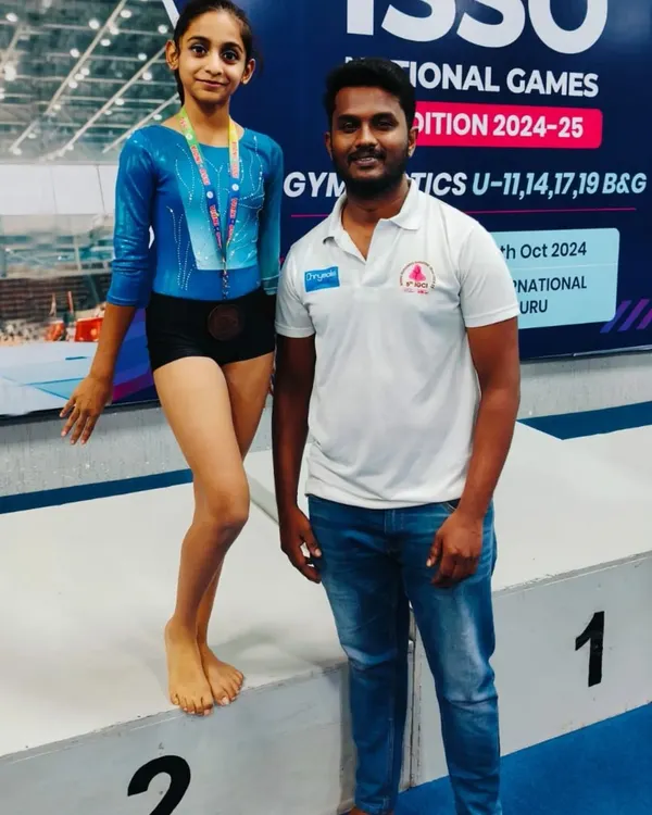 A proud moment at the ISSO National Games, celebrating a second-place finish on the vault for our U11 gymnast. Our competitive program is designed to prepare athletes for high-level events.