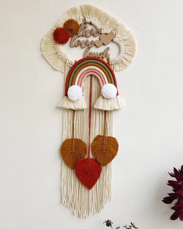 This large, personalized wall hanging was created for a couple with the motto "Live, Love, Laugh." It combines a rainbow, hearts, and custom lettering for a truly meaningful piece.