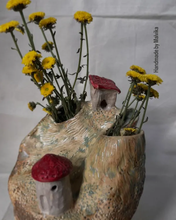 A piece from my 'Houses on Cliff' series, styled with fresh yellow flowers. Each house is hand-built and attached to a wheel-thrown base, creating a miniature landscape inspired by my mountain travels.