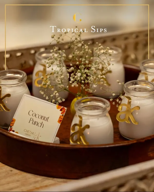 Our creamy Coconut Punch is a tropical delight. Served in charming glass jars with custom initial tags, it's a personalized and refreshing welcome drink for your guests.