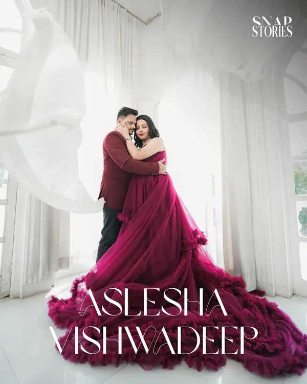 A romantic embrace captured in a bright, airy room with flowing white curtains. This style of pre-wedding photography creates a soft, dreamy, and elegant portrait.