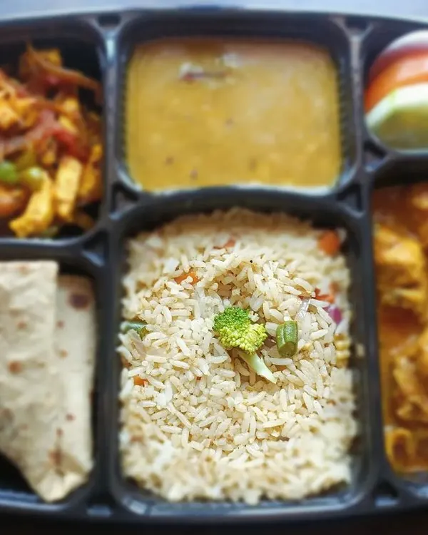 This is what a typical full meal looks like. It includes veg fried rice, chicken curry, paneer sabzi, dal, roti, and a fresh salad. A complete and satisfying meal delivered to you.
