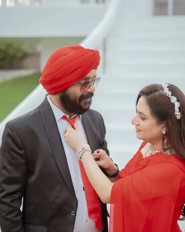A sweet, candid moment during an anniversary shoot. The bride adjusts her husband's tie, a small gesture of love and care that I love to capture.