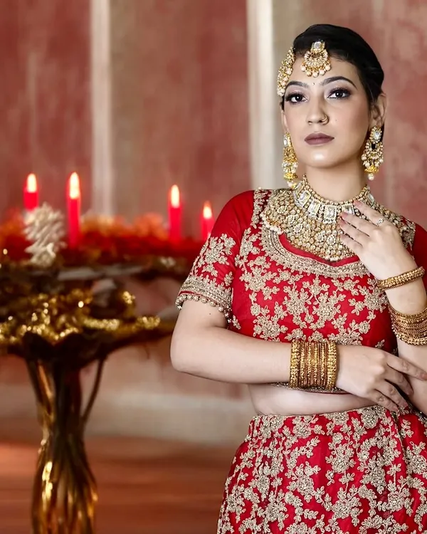 This is my signature North Indian bridal look. I focus on creating a flawless, radiant base that looks stunning in photos and lasts through all the ceremonies, paired with classic eyes and a bold red lip that complements the traditional red lehenga.