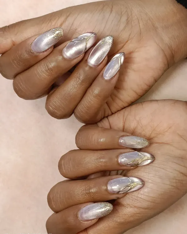 I combined three popular effects in this one set: a pearlescent cat-eye base, a touch of gold chrome for linework, and a sprinkle of fine glitter on the tips. This is a perfect example of a custom gel extension set.