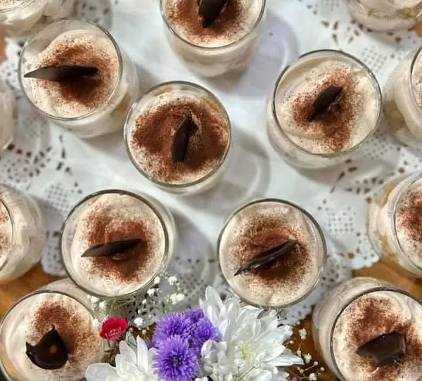 A tray of my sophisticated Tiramisu cups. This classic Italian dessert, with its layers of coffee-soaked ladyfingers and creamy mascarpone, is always an elegant choice for any occasion.