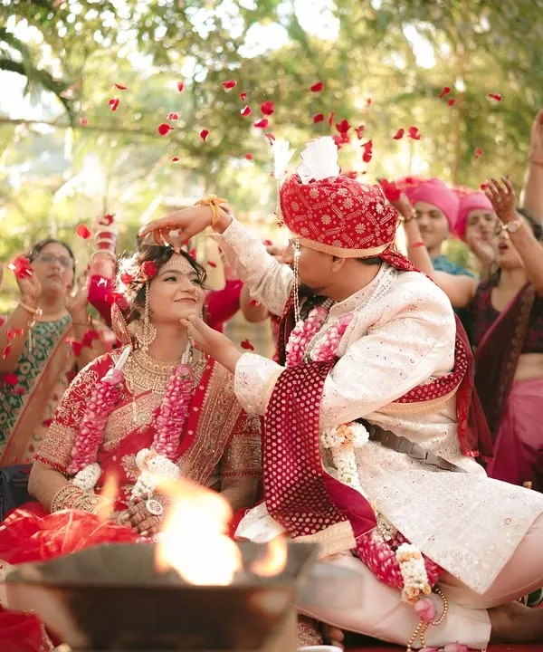 A moment of pure celebration as the couple is showered with rose petals by their loved ones during the ceremony.