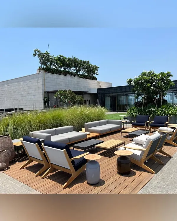 This rooftop lounge in Mumbai was designed for entertaining. We used a combination of wooden decking, modern outdoor sofas, and strategically placed planters to create a spacious and elegant setting with panoramic views.