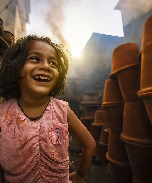 A moment of pure joy captured in the heart of Dharavi's potter's colony. This portrait is part of a larger series documenting the vibrant life and spirit of the people in this community.