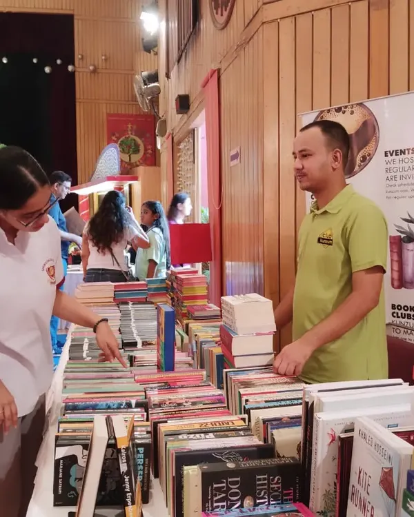 Our team member helps a student browse through our collection at the Springdales school book fair. We enjoy interacting with students and helping them find their next favorite book.