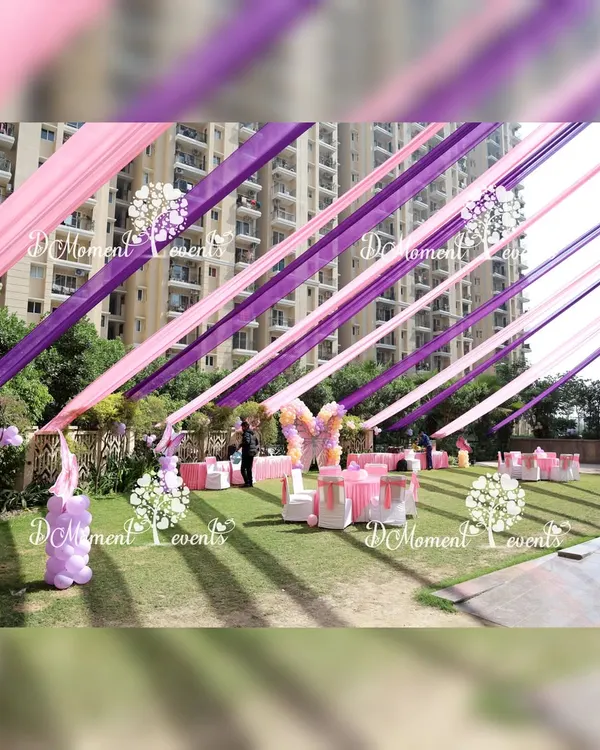 We transformed this outdoor lawn into a magical wonderland with vibrant pink and purple ceiling drapes for a butterfly-themed birthday. This full-scale event design included themed decor, seating arrangements, and activity stations, creating a completely immersive experience for the guests.