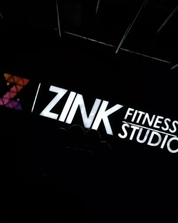 The Zink Fitness Studio sign lit up at night. This is your beacon for a healthier, stronger, and happier life.