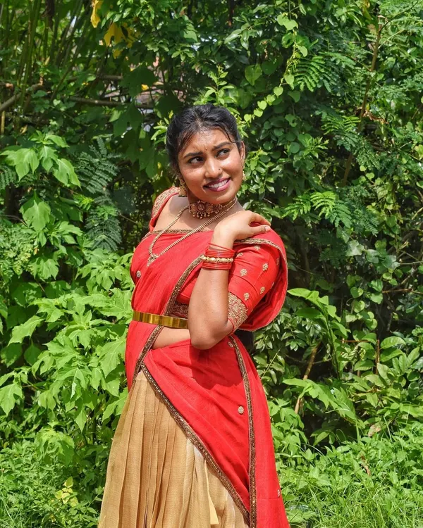 A happy client celebrating her housewarming in a traditional red and gold half-saree. This is exactly why I started this rental service, to be a part of your joyful moments without the stress of buying.