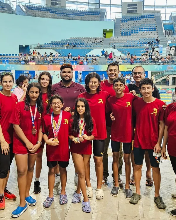 The complete team, including swimmers and proud parents, after a successful meet. This support system is a critical part of our academy's success and creates a powerful community.