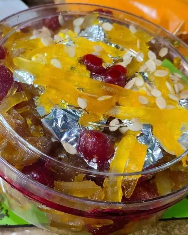 A close-up of my special mixed fruit murabba. I make this festive preserve with mango, apple, and red berries, and garnish it with edible silver leaf and sesame seeds. It's a beautiful and delicious gift for your loved ones.
