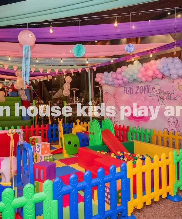 Our full-scale Rainbow Kids Play Area, featuring a multi-colored soft play structure with slides, climbers, a ball pit, and rockers, all safely enclosed.