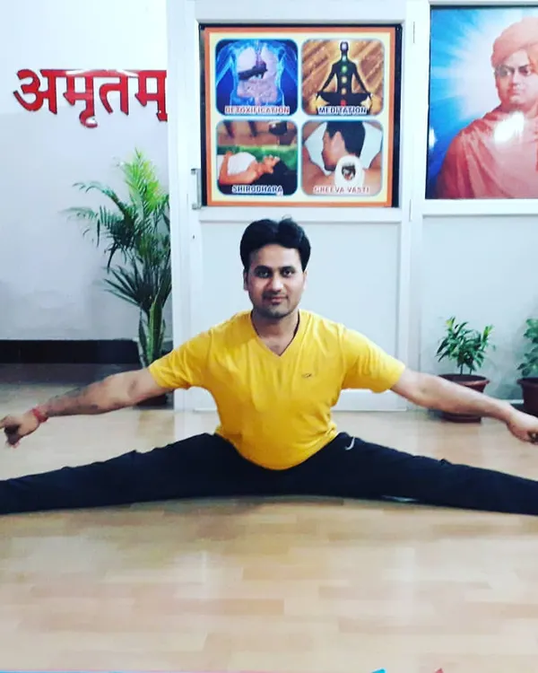 My personal practice is the foundation of my teaching. Here I am in Upavistha Konasana (Wide-Angled Seated Forward Bend), a deep stretching pose that requires patience and consistent practice, principles I encourage in all my students.