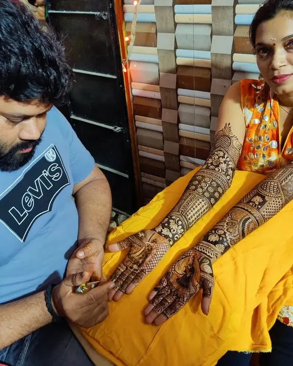 A happy client proudly displaying her intricate bridal mehndi, applied right here in my studio. This is the level of quality and detail you will learn to produce with my hands-on instruction.