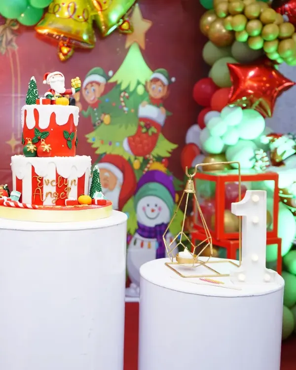 A close-up of a festive Christmas-themed birthday cake and decor, perfect for a December baby.