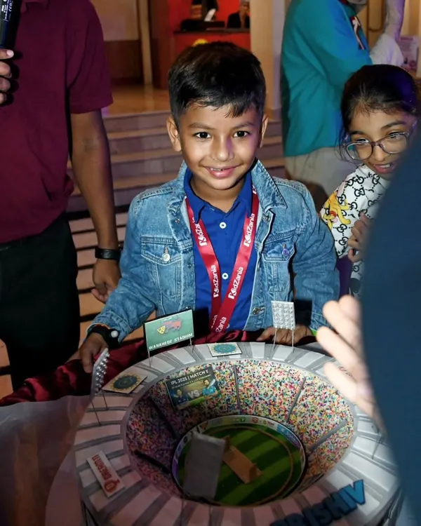 The birthday boy, Prishiv, beaming with joy in front of his incredible cricket stadium cake. Seeing smiles like this is why I love my job.