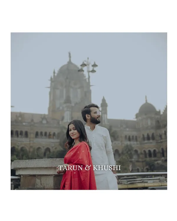 A classic portrait with the iconic Chhatrapati Shivaji Maharaj Terminus in the background. This shot blends the couple's story with the timeless architecture of Old Bombay.
