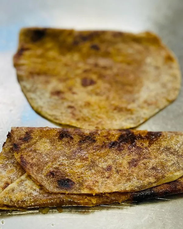 This is the classic bele holige, a sweet flatbread that is a centerpiece of Karnataka celebrations. I prepare it fresh to ensure that authentic, homemade taste.