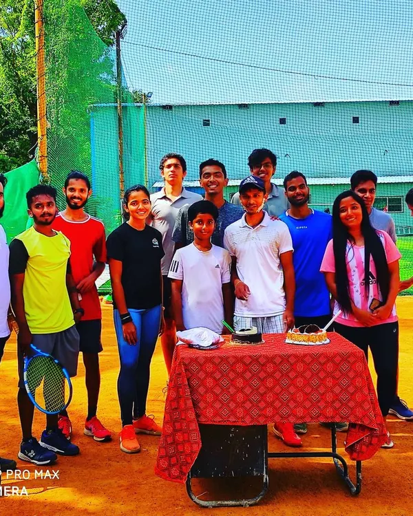We are a close-knit group. Here, our players and coaches gather on the court to celebrate a birthday, which is a common sight at our academy.