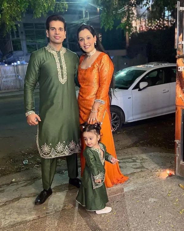This is what family celebrations are all about. Here, we created a coordinated look for Diwali, with the father and my daughter Aarriya twinning in bottle green kurta sets featuring intricate leather embroidery. I wore a complementary vibrant orange Anarkali to complete our family's festive story.
