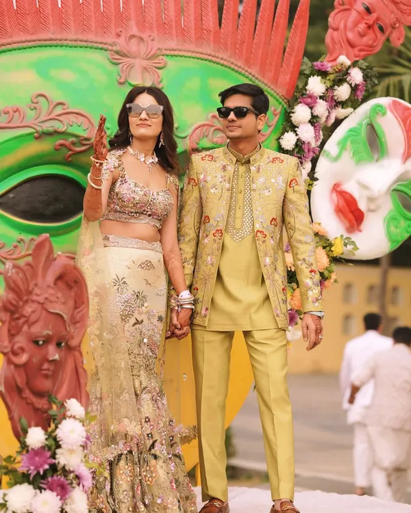 The happy couple at their vibrant Mehendi ceremony. My client's custom lime-green, embroidered bandhgala set perfectly complements the festive decor and his bride's stunning lehenga.